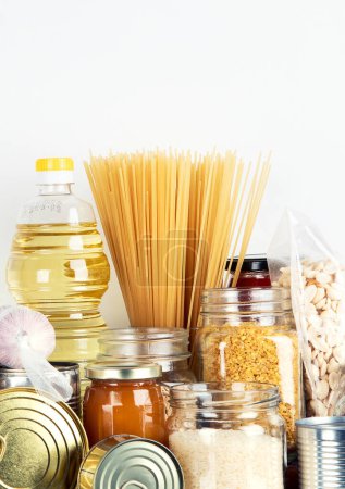 Foto de Food supplies. Crisis food stock. Different glass jars with grains, pasta, oil, nut, canned food - Imagen libre de derechos