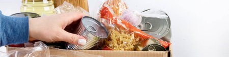 Photo for Food donation box of different products  on light background, top view. Food donations or delivery concept. Panorama, banner, copy space - Royalty Free Image