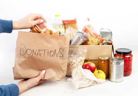 Photo for Food donation box of different products  on light background, top view. Food donations or delivery concept. - Royalty Free Image