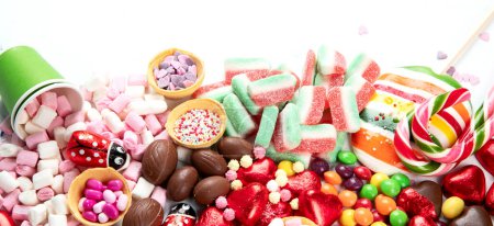 Photo for Assortment of colorful candy on a white background. Top view. Panorama with copy space. - Royalty Free Image