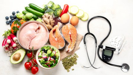 Photo for Top view of healthy food in plate with stethoscope, cholesterol diet and diabetes control on white background. World health day and medical concept. - Royalty Free Image
