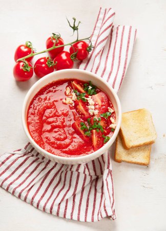 Photo for Tomato soup on white table, top view. - Royalty Free Image