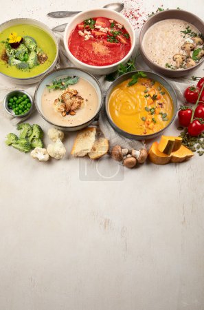 Photo for Variety of vegetables cream soups in small pots. Top view. Concept of healthy eating or vegetarian food. Copy space. - Royalty Free Image