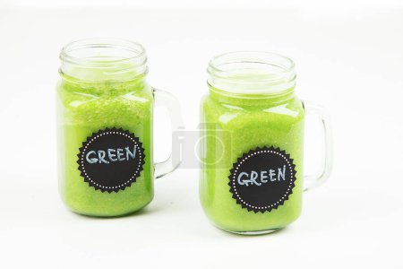 Photo for Healthy green smoothie  in a jar mug  on white background. - Royalty Free Image