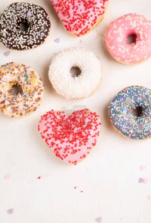 Photo for Donuts pattern. Top view of assorted glazed donuts. Colorful donuts with icing. Various colorful glazed doughnuts with sprinkles on a light background. - Royalty Free Image