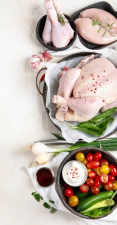 Photo for Poultry. Carcass and meat in pieces with vegetables. Meat composition on a white background. Top view. Copy space - Royalty Free Image
