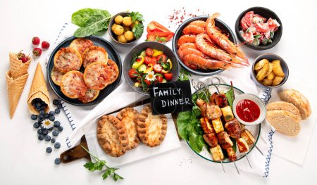Photo for Summer picnic food, grilled meat, kebab, vegetable salad, fruit salad, pizza, sandwiches and snacks on a white background. Top view. - Royalty Free Image