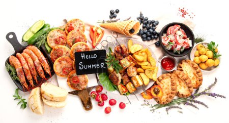 Photo for Summer picnic food, grilled meat, kebab, vegetable salad, fruit salad, pizza, sandwiches and snacks on a white background. Top view. - Royalty Free Image