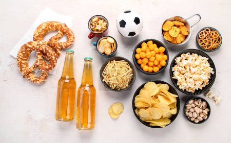 Photo for Beer bootles,  snacks and ball on  table. Top view - Royalty Free Image