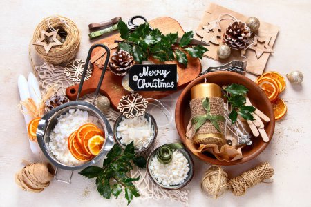 Photo for Making Christmas arrangement with dried oranges on a white background. Christmas craft handmade decor. New year celebration. Top view. - Royalty Free Image