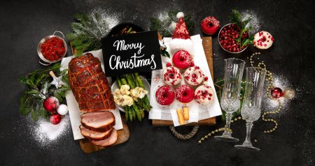 Photo for Baked ham with vegetablesand donuts on dark background. Christmas food. Top view. Banner. - Royalty Free Image