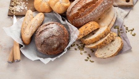 Photo for Assortment of various delicious freshly baked bread on white background, top view. - Royalty Free Image