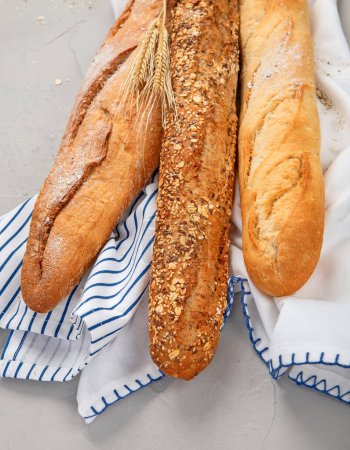 Photo for Fresh baguette bread on light background. Traditional French food. - Royalty Free Image