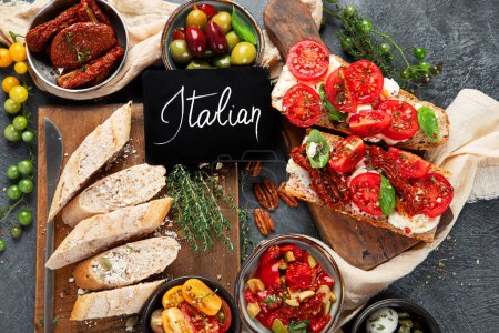 Photo for Italian antipasti snacks set. Tasty bruschettas with cheese, sun-dried tomatoes. Traditional food concept. Top view. - Royalty Free Image