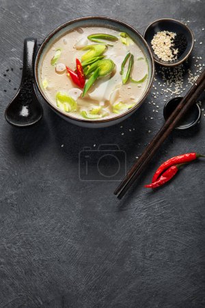 Photo for Bowl of leek soup with chili pepper on dark background. Food concept. Copy space. - Royalty Free Image