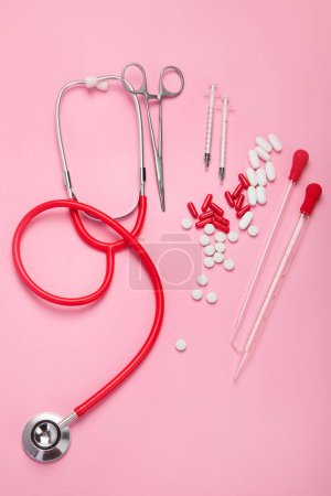 Photo for Various medical equipment, pipette, drugs, tablets, capsules, spray on pink background. Top view - Royalty Free Image