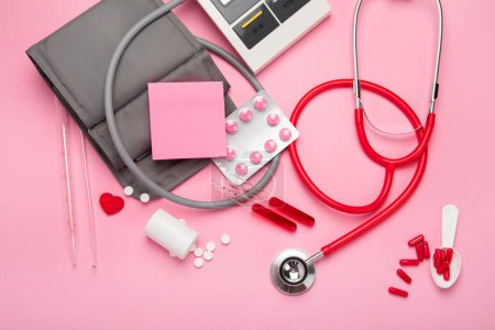 Photo for Stethoscope, medicine, tubs on pink background. Medical stuff. Top view. - Royalty Free Image
