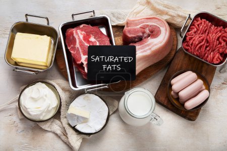 Photo for Saturated fats on tables. Raw meat, sausages, cheese, butter. Bad food concept. Top view - Royalty Free Image