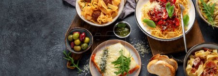 Photo for Pasta. Assortment of Italian pasta dishes, including spaghetti Bolognese, penne, tortellini, ravioli and others on a black background. Top view. Panorama with copy space. - Royalty Free Image