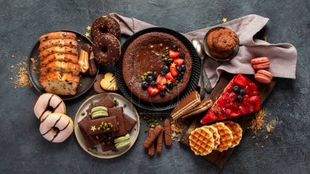 Photo for Tasty cake, cookies, waffles, macaroons, muffin. Delicious desserts on dark background. Food concept. Top view - Royalty Free Image