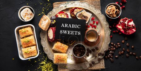 Photo for Hot tasty coffee with various pieces of turkish delight desets on a dark background. Traditional arabian food. Top view, banner. - Royalty Free Image