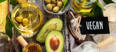 Photo for Avocado, almonds, seeds, linseeds, olives and oils on a light background, top view. Alternative oils concept. Panorama. - Royalty Free Image