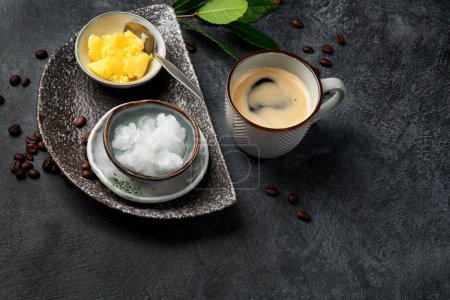 Photo for Bulletproof keto coffee. Ketogenic diet. Hot dring with coconut oil and ghee butter on dark background. Copy space - Royalty Free Image