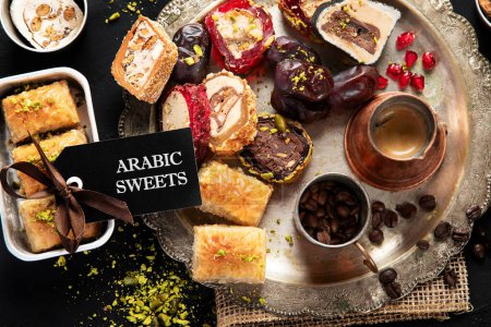 Photo for Hot tasty coffee with various pieces of turkish delight desets on a dark background. Traditional arabian food. Top view. - Royalty Free Image