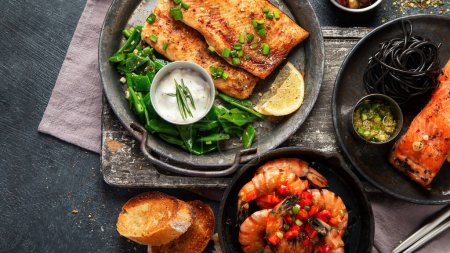Photo for Grilled salmon fish fillet with lemon and strimps. Sea food dishes assorty. Healthy concept. Top view - Royalty Free Image