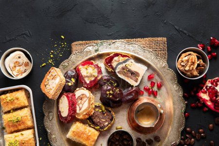 Photo for Hot tasty coffee with various pieces of turkish delight desets on a dark background. Traditional arabian food. top view, copy space - Royalty Free Image