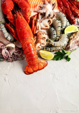 Photo for Assortment of fresh raw fish and seafood. Healthy and balanced diet or cooking concept. Top view. Copy space. - Royalty Free Image