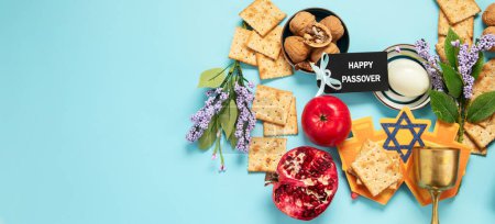 Photo for Passover celebration concept. Matzah, red kosher walnut and spring beautiful flowers on a blue background. Traditional ritual Jewish bread. Panorama with copy space. - Royalty Free Image