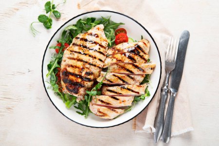 Photo for Grilled chicken breast, fillet, steak and fresh vegetable salad, on a white background. Healthy keto, ketogenic lunch menu with chicken meat and organic veggies. Top view. - Royalty Free Image