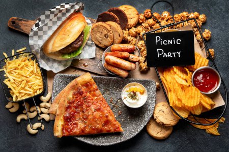 Photo for Fast food on a dark background. Junk food for your heart and skin. Trans fat concept. Top view - Royalty Free Image