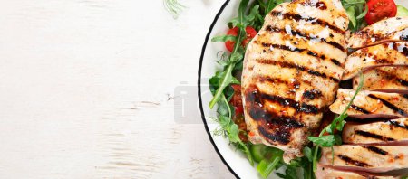 Photo for Grilled chicken breast, fillet, steak and fresh vegetable salad, on a white background. Healthy keto, ketogenic lunch menu with chicken meat and organic veggies. Top view. Panorama with copy space. - Royalty Free Image