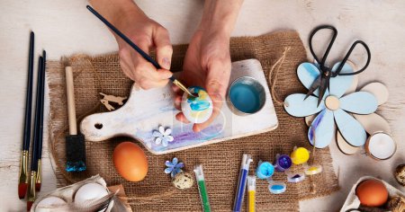Photo for Happy Easter, painting eggs. Paints, pens, decorations for coloring eggs for holiday on a white background. Top view. Panorama. - Royalty Free Image