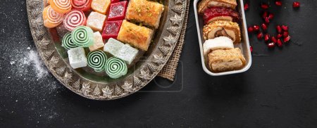 Photo for Traditional Turkish Pastry Pistachio Dry Baklava with coffee and delights. Conceptual image of celebrations. Top view. Panorama with copy space. - Royalty Free Image