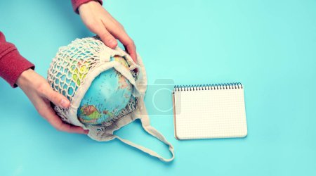 Photo for Hand holding globe on blue background. Environment protection. Top view - Royalty Free Image