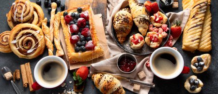 Photo for Different tasty freshly baked pastries on dark background. Top view. Panorama. - Royalty Free Image