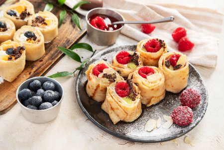 Photo for Asian sweet sushi pancake. Rolls with cream cheese berry and fruits - Royalty Free Image