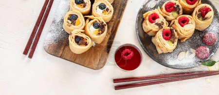 Photo for Asian sweet sushi pancake. Rolls with cream cheese berry and fruits. Top view, copy space - Royalty Free Image