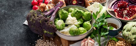 Photo for Vegan food. Pepper, broccoli, cabbage, garlic, mushrooms, pomegranate on a dark background. Copy space, banner - Royalty Free Image