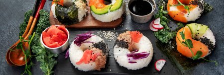 Sushi donuts on a dark background. Hybrid trend food. Top view