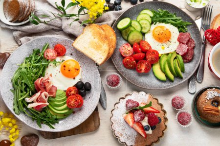 Photo for Breakfast served with coffee, fresh bakery, eggs, salad, meat and fruits. Holiday concept. Top view. - Royalty Free Image