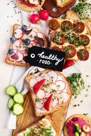 Breakfast with vegetables. toasts, tomato, cucumber, radish, avocado. Vegan healthy food concept. Top view