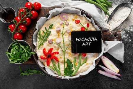 Raw focaccia art on dark background. Italian food concept. Top view