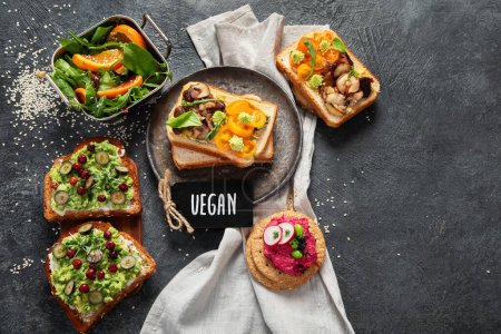 Photo for Vegan toast with avocado,mushroom and fresh salad on dark background. Vegetarian food concept. Top view, copy space - Royalty Free Image