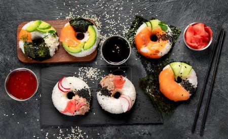 Photo for Sushi donuts on a dark background. Hybrid trend food. Top view - Royalty Free Image