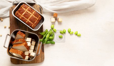Photo for Soy food. Baked tofu cheese on a board, soybeans. Vegan product. Top view, copy space - Royalty Free Image