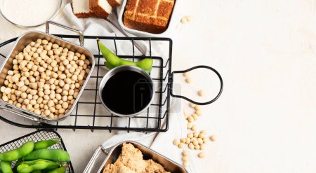 Photo for Various soy products with soy bean, tofu, soy sauce and soy milk on a light background. Top view. Panorama with copy space. - Royalty Free Image